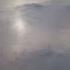 An Aerial View Of A Plane Flying Over The Turbines Spinning On A Windy Winter Day