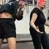 Elderly Woman Performs Zumba Dance With Instructor