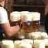 Waitress Carries Multiple Heavy Beer Filled Mugs Together