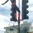 SPIDER MAN DANCING ON THE PUBLIC TRAFFIC LIGHT POLE IN FRONT OF EVERYBODY WATCHING